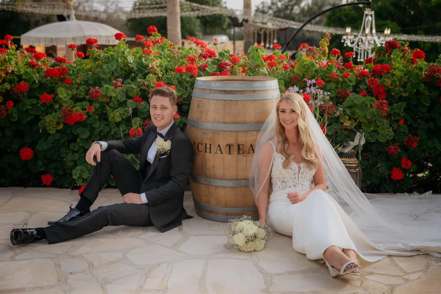 Bride and groom seated together at L'Chateau before their wedding celebration